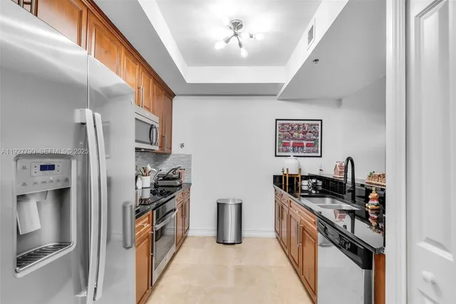 a kitchen with stainless steel appliances granite countertop a stove and a refrigerator