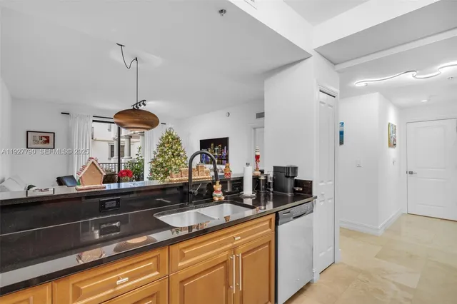 a kitchen with granite countertop a sink and a chandelier
