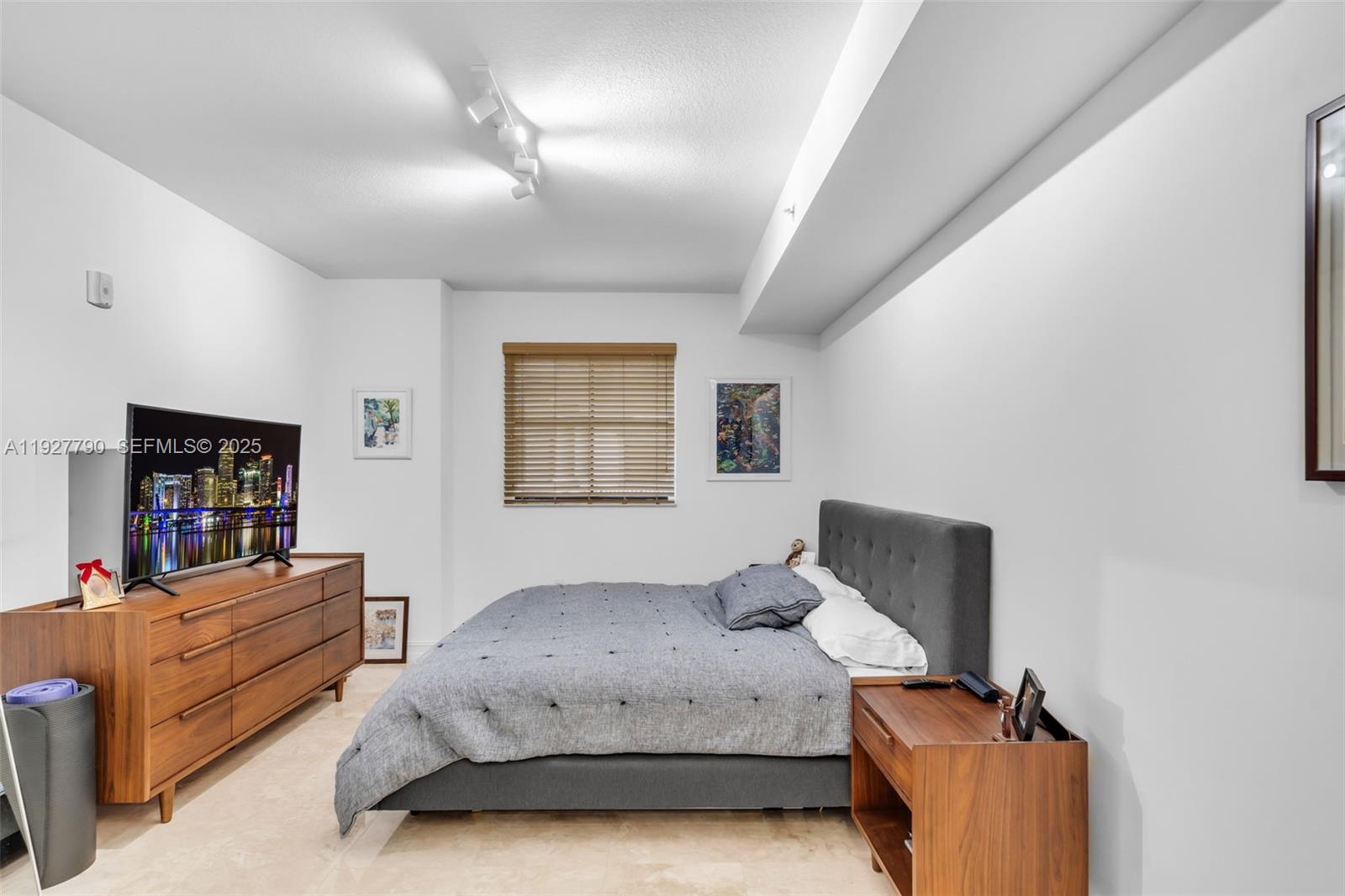 1650 Galiano Street, Unit 311 Coral Gables, FL 33134 - Photo 13 of 32 a bedroom with a bed and a flat screen tv