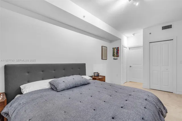 a bedroom with a bed and cabinets