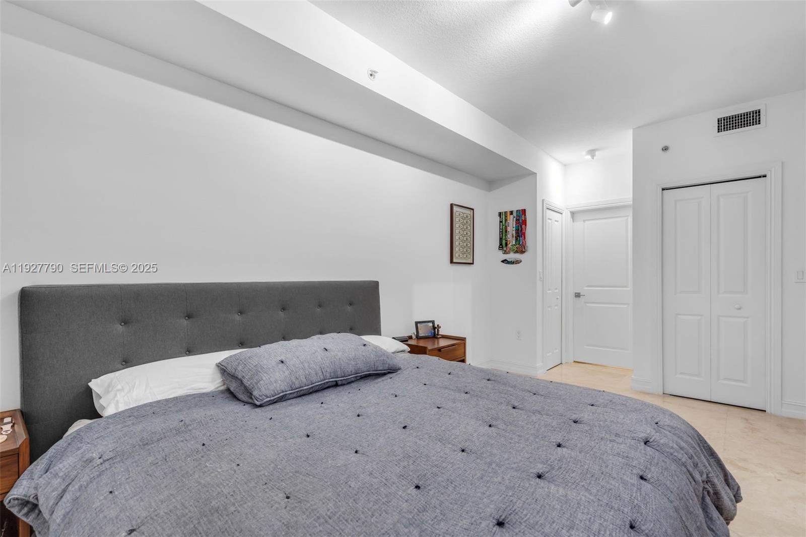 1650 Galiano Street, Unit 311 Coral Gables, FL 33134 - Photo 14 of 32 a bedroom with a bed and cabinets