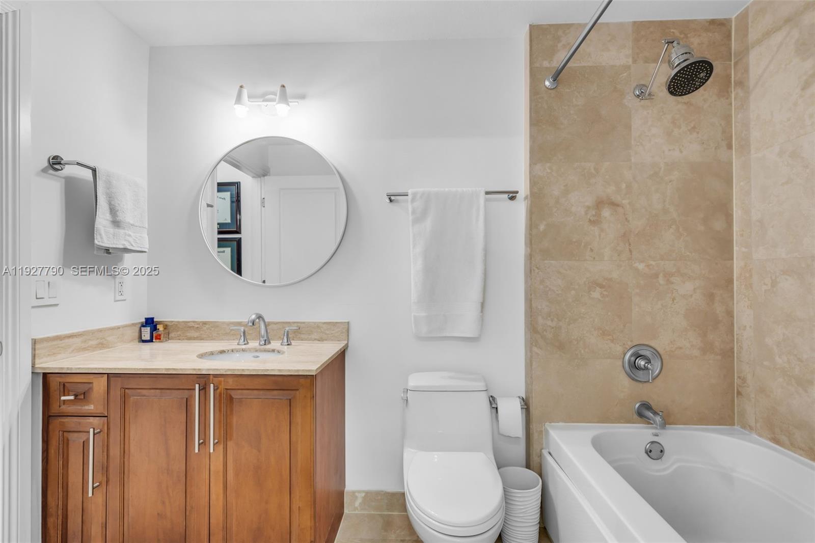 1650 Galiano Street, Unit 311 Coral Gables, FL 33134 - Photo 15 of 32 a bathroom with a sink vanity mirror and toilet