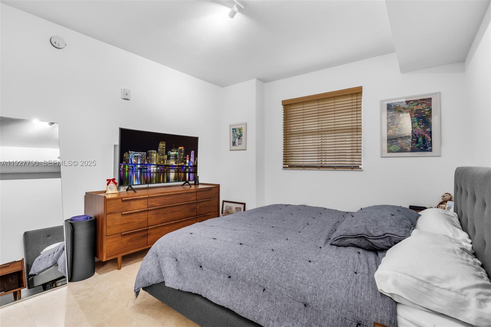 1650 Galiano Street, Unit 311 Coral Gables, FL 33134 - Photo 17 of 32 a bedroom with a bed and a dresser