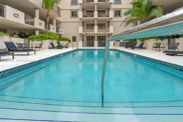 a view of swimming pool with outdoor seating