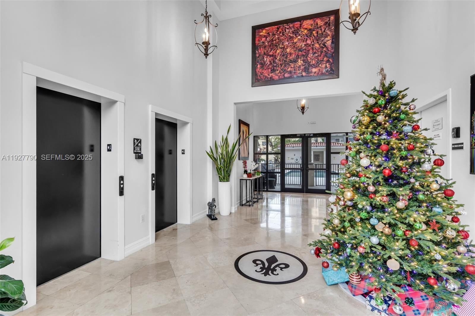 1650 Galiano Street, Unit 311 Coral Gables, FL 33134 - Photo 2 of 32 a view of entryway with a flower garden