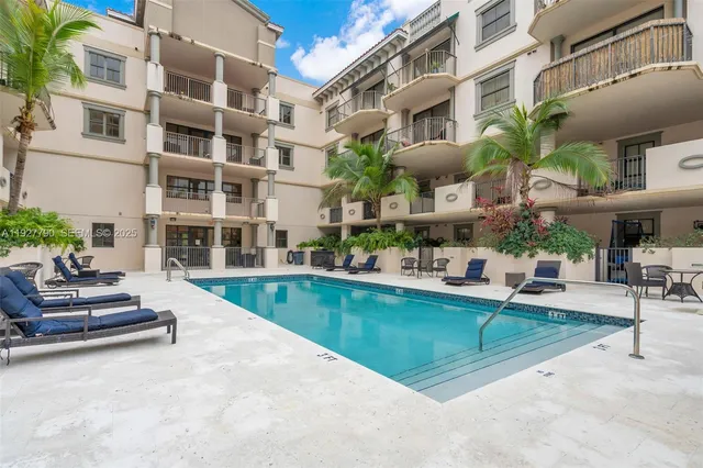 a view of a building with sitting area and swimming pool