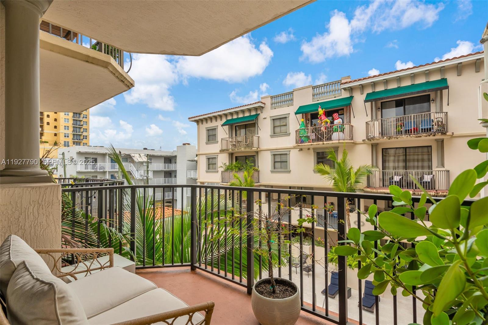 1650 Galiano Street, Unit 311 Coral Gables, FL 33134 - Photo 22 of 32 a balcony with wooden floor and outdoor seating