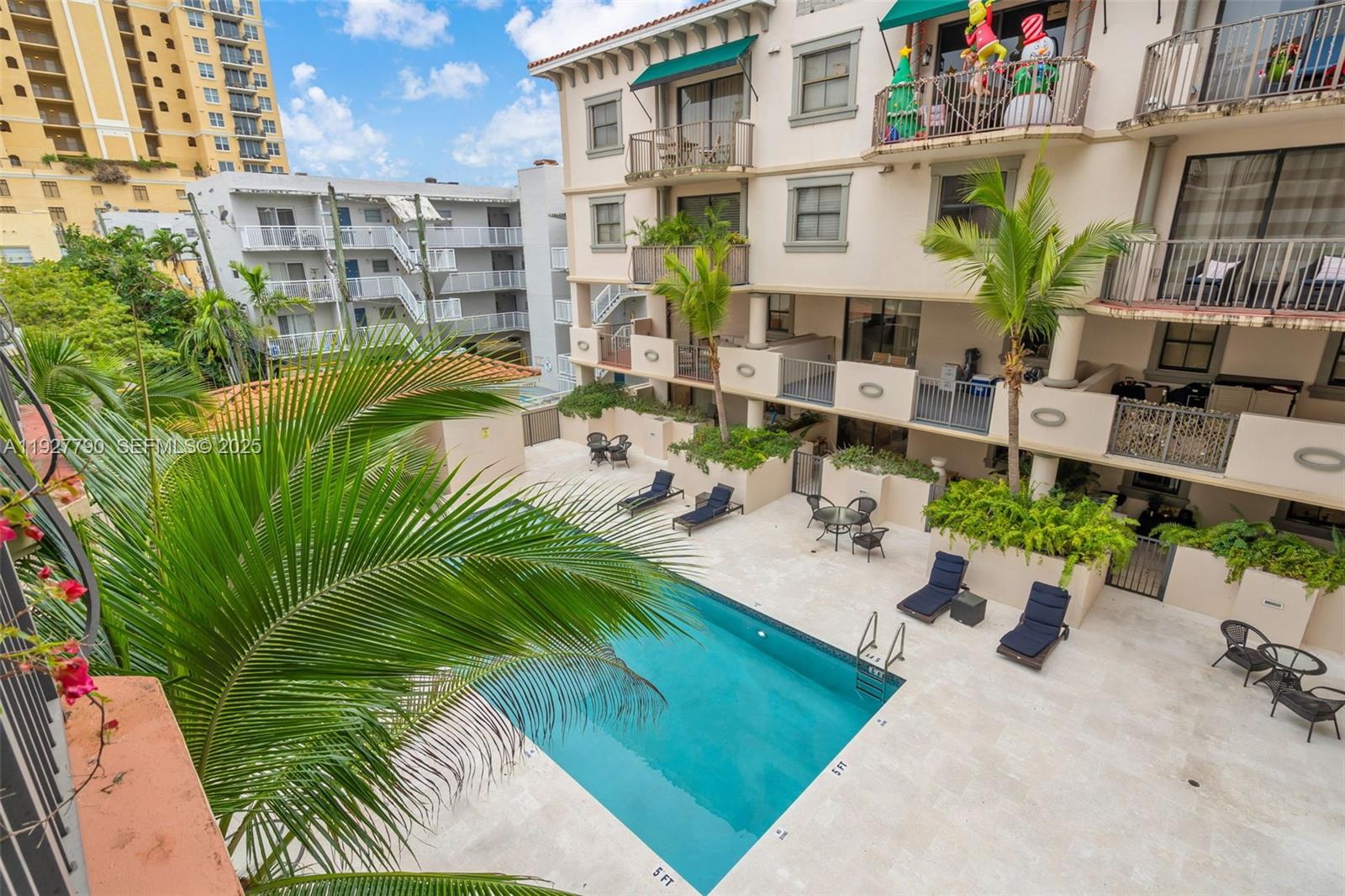 1650 Galiano Street, Unit 311 Coral Gables, FL 33134 - Photo 24 of 32 a view of a swimming pool with a patio