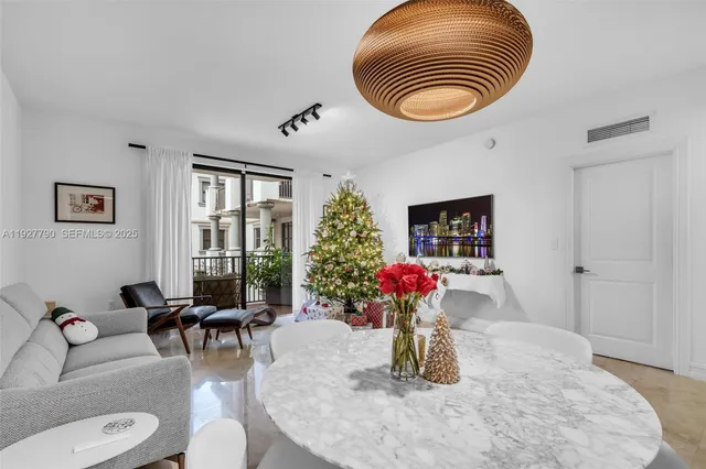 a dining room with furniture and a large window