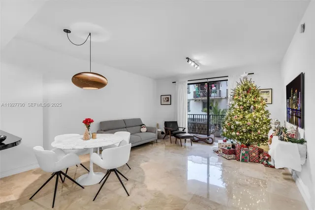 a living room with furniture potted plant and large window
