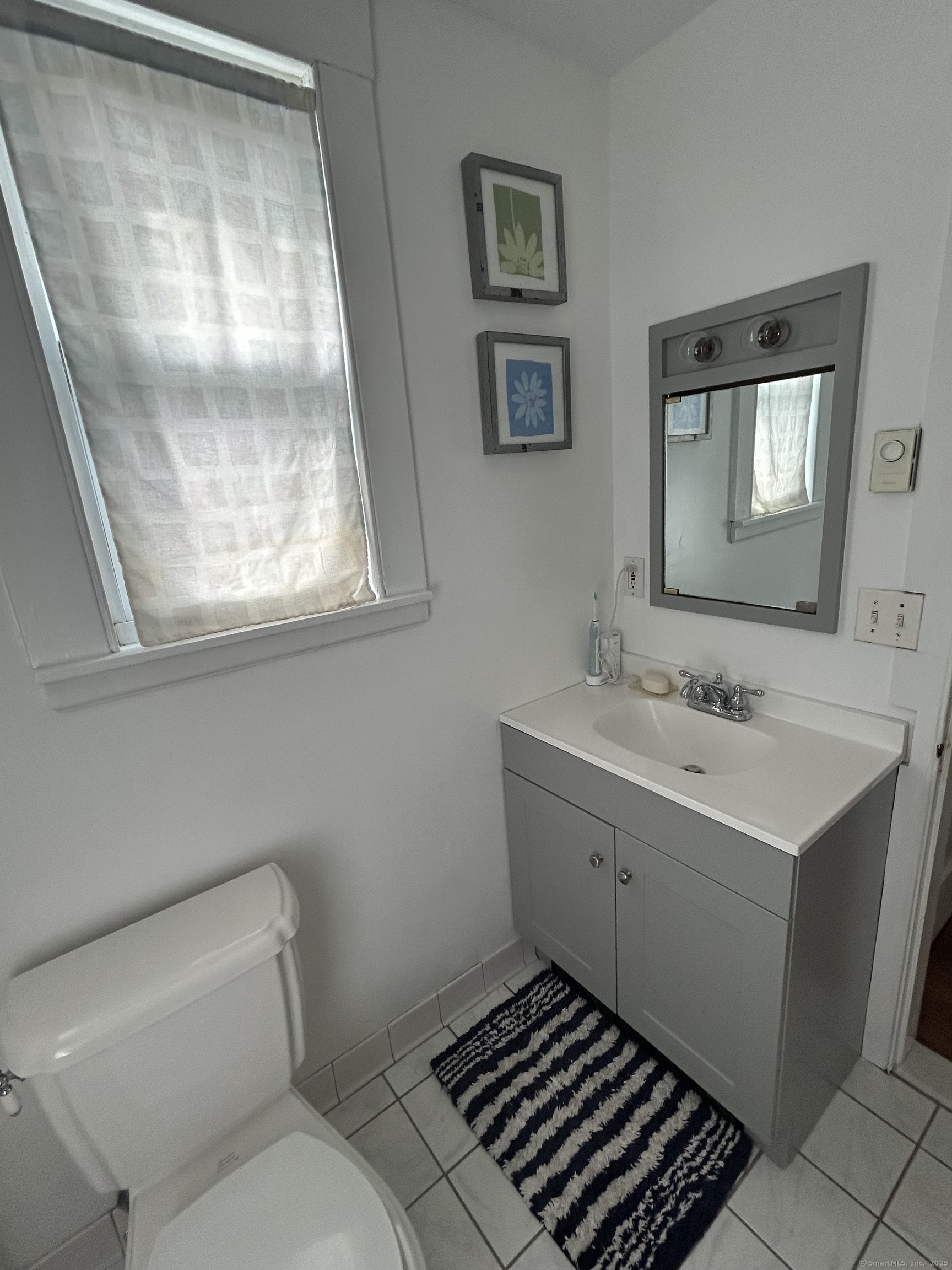 21 Acushnet Street Naugatuck, CT 06770 - Photo 11 of 27 a bathroom with a sink toilet and shower