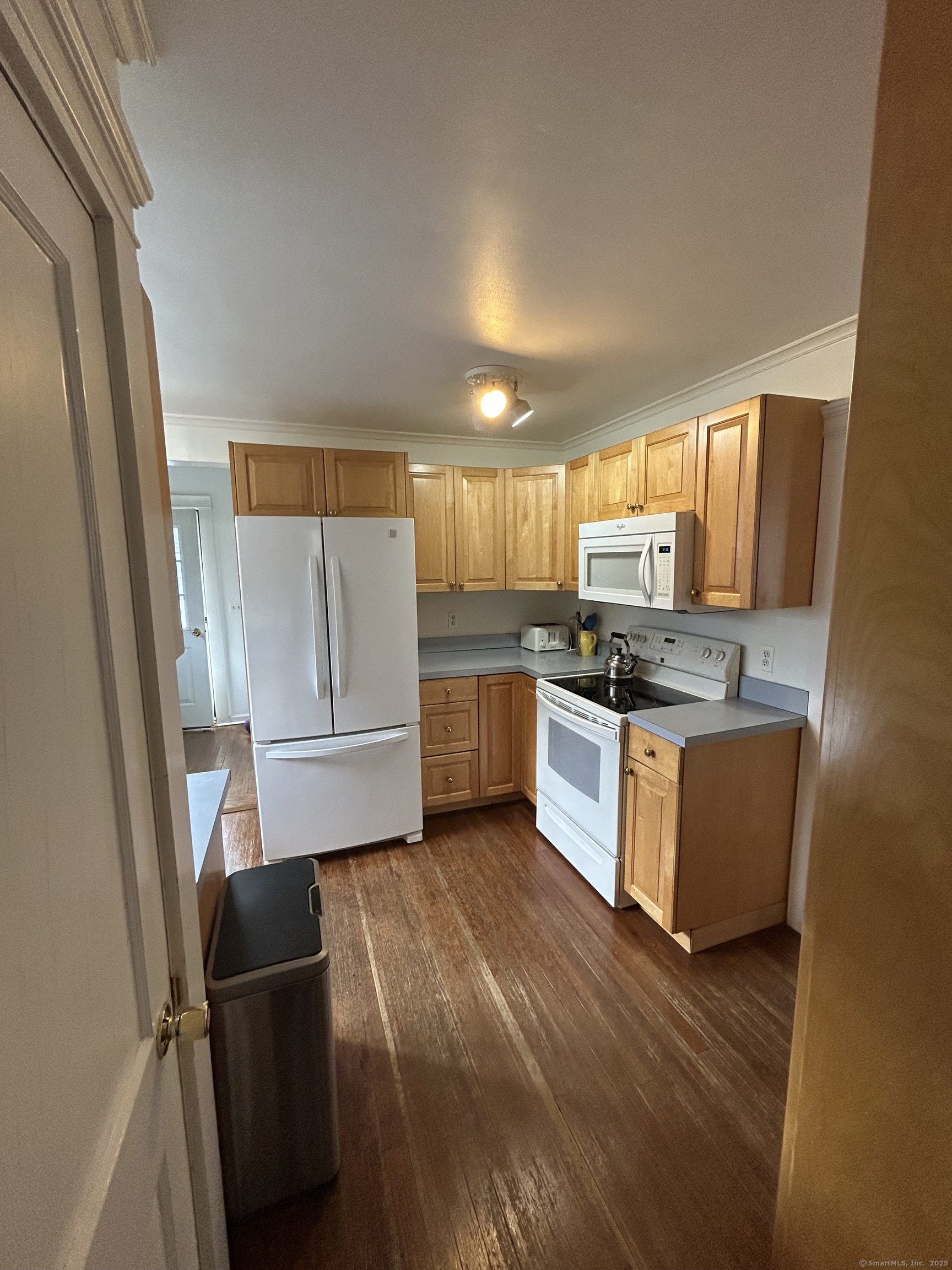 21 Acushnet Street Naugatuck, CT 06770 - Photo 3 of 27 a kitchen with wooden floors stainless steel appliances and window