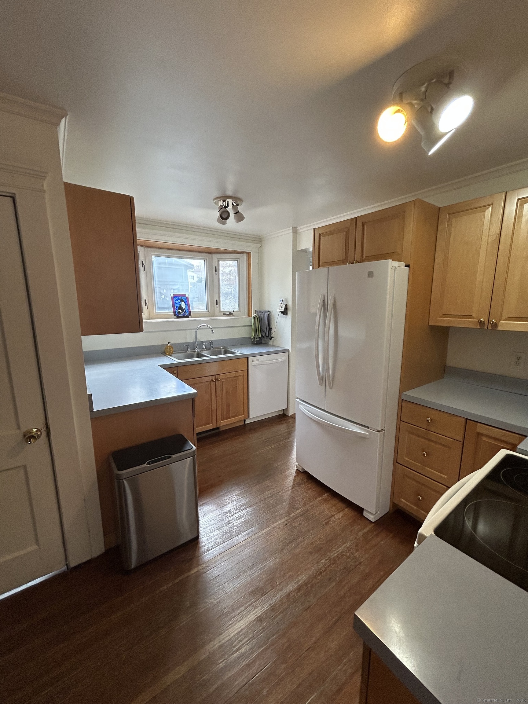 21 Acushnet Street Naugatuck, CT 06770 - Photo 4 of 27 a kitchen with stainless steel appliances a refrigerator and wooden floor