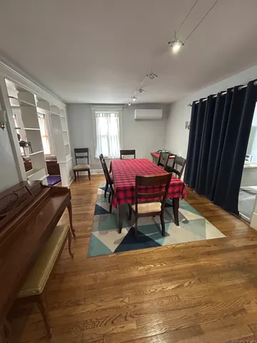 a living room with furniture a wooden floor and a window