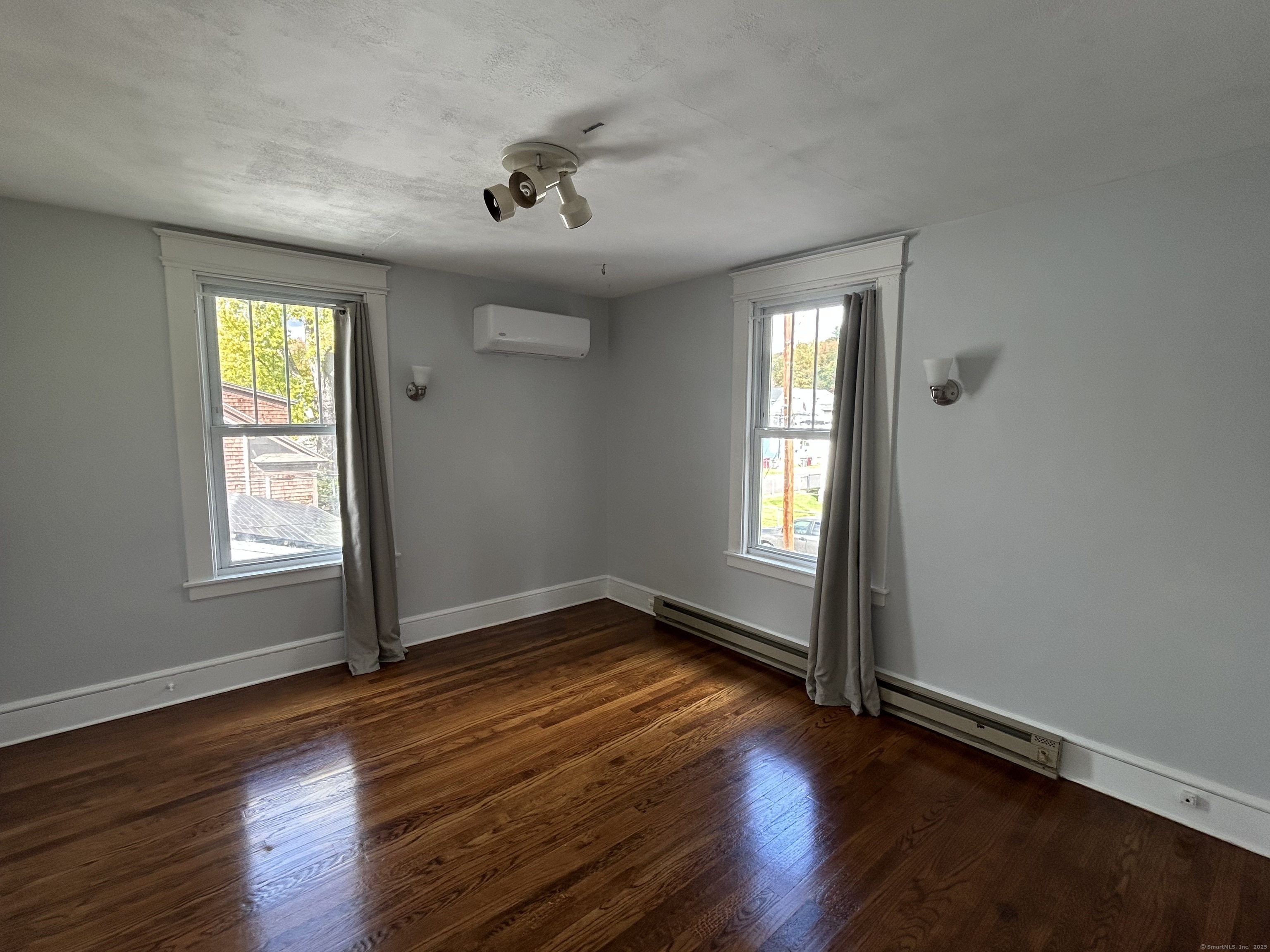 21 Acushnet Street Naugatuck, CT 06770 - Photo 7 of 27 an empty room with wooden floor and windows