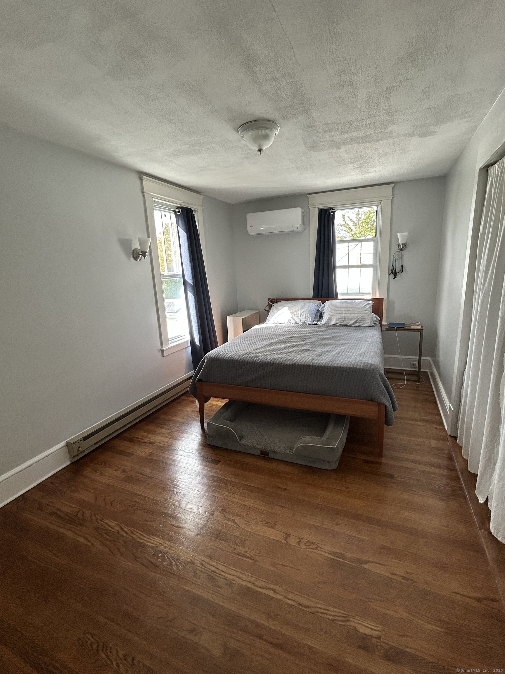 21 Acushnet Street Naugatuck, CT 06770 - Photo 9 of 27 a spacious bedroom with a bed and wooden floor