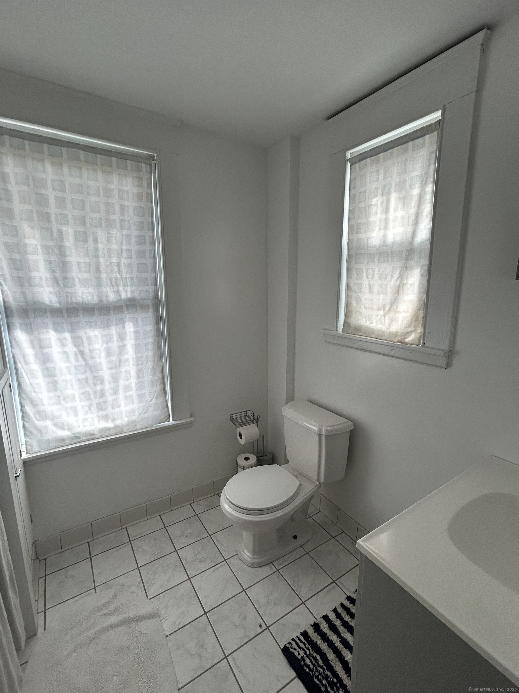21 Acushnet Street Naugatuck, CT 06770 - Photo 10 of 27 a bathroom with a sink toilet and tub