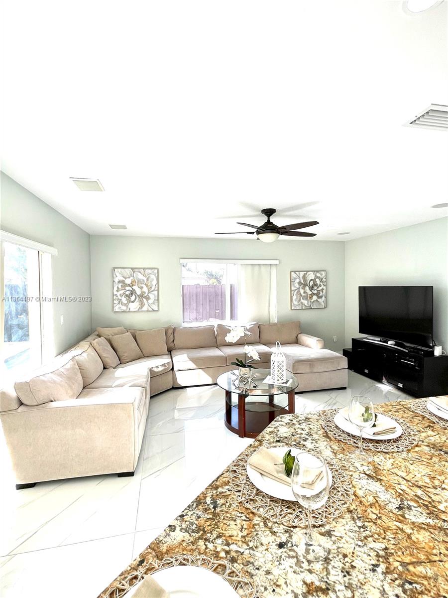 15542 Southwest 148th Terrace Miami, FL 33196 - Photo 15 of 38 a living room with furniture and a flat screen tv
