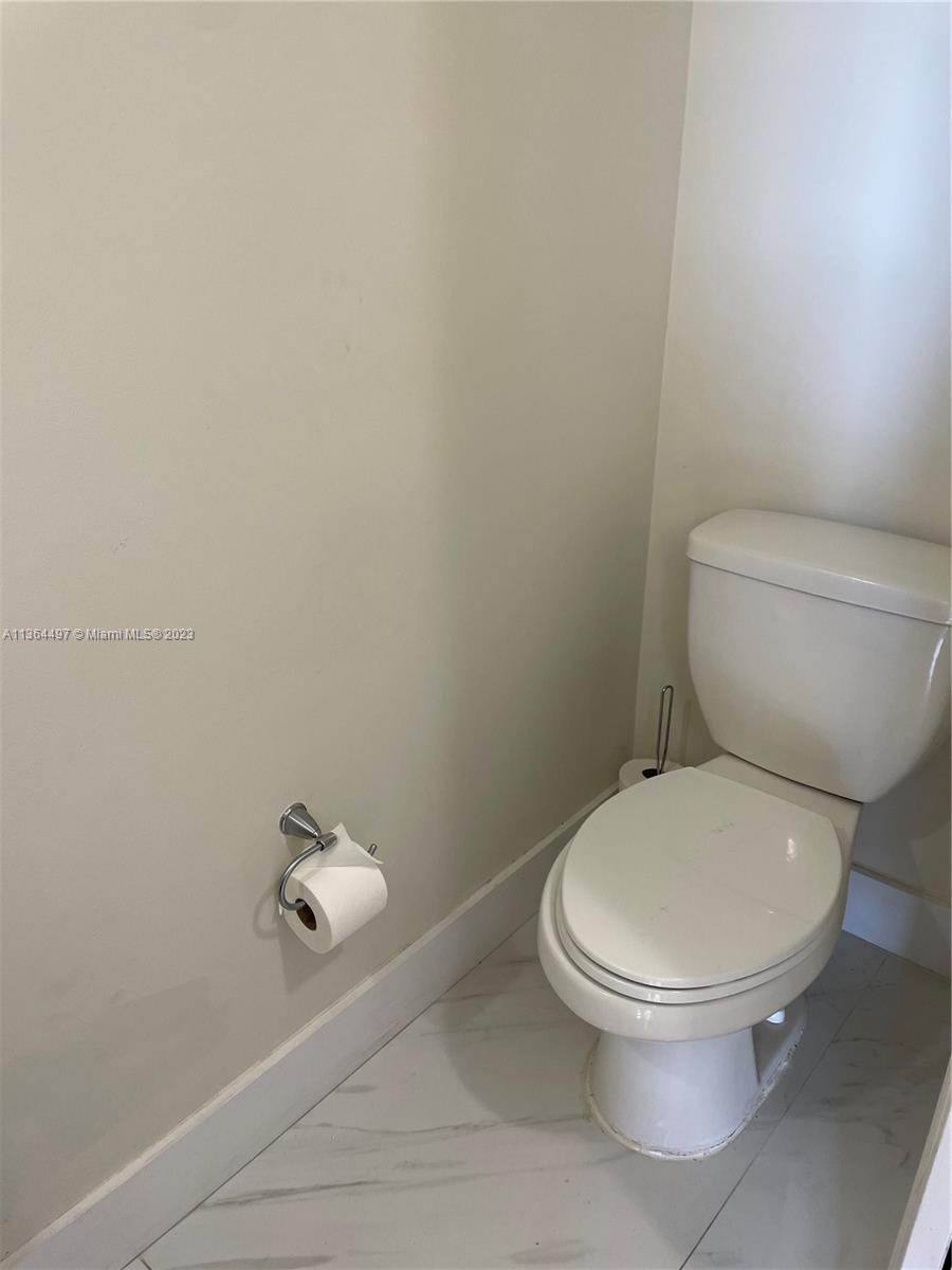 15542 Southwest 148th Terrace Miami, FL 33196 - Photo 17 of 38 a white toilet sitting next to a white wall