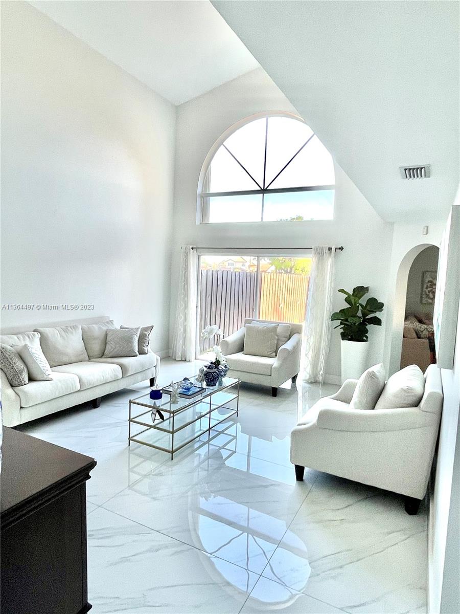 15542 Southwest 148th Terrace Miami, FL 33196 - Photo 20 of 38 a living room with furniture and a large window