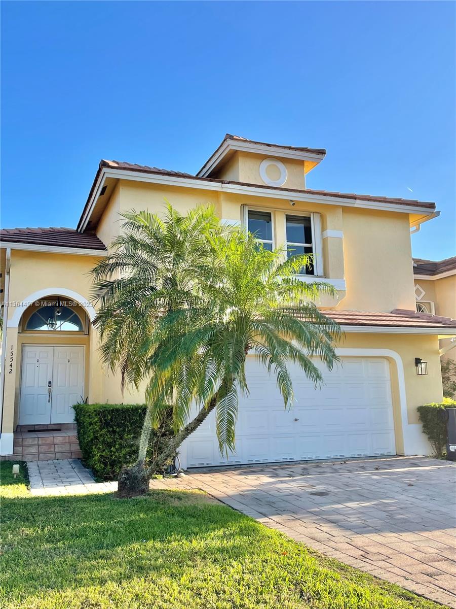 15542 Southwest 148th Terrace Miami, FL 33196 - Photo 2 of 38 a front view of a house with garden