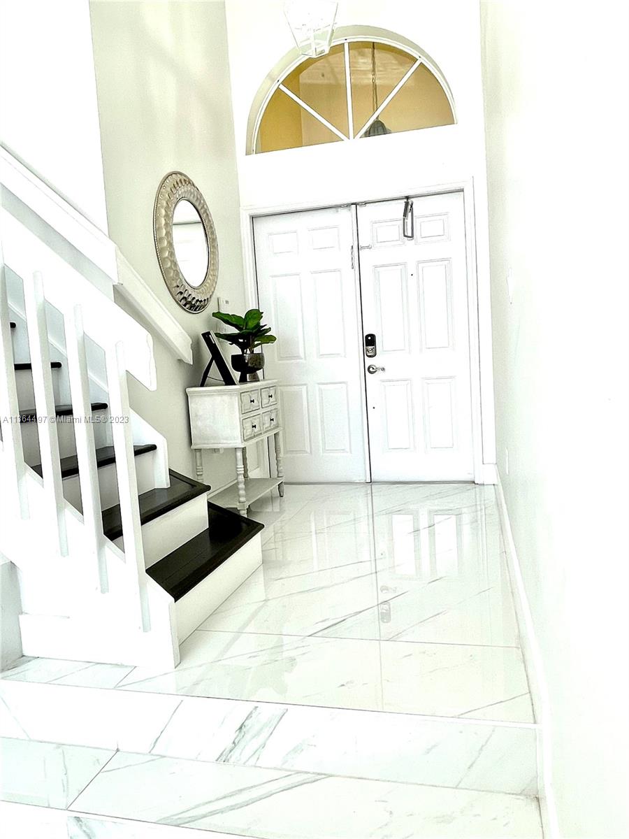 15542 Southwest 148th Terrace Miami, FL 33196 - Photo 23 of 38 a view of staircase with a white door