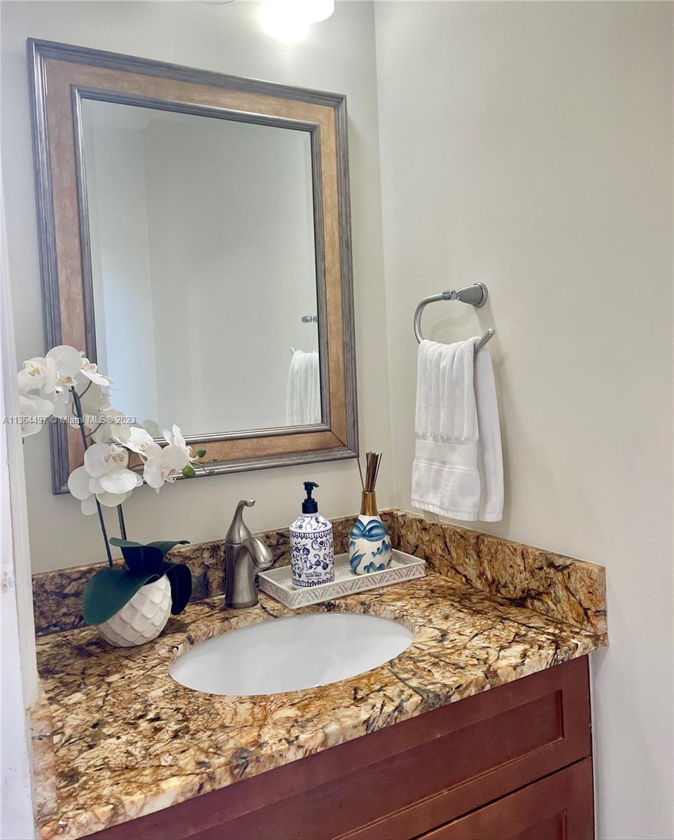 15542 Southwest 148th Terrace Miami, FL 33196 - Photo 28 of 38 a bathroom with a granite countertop sink and a mirror