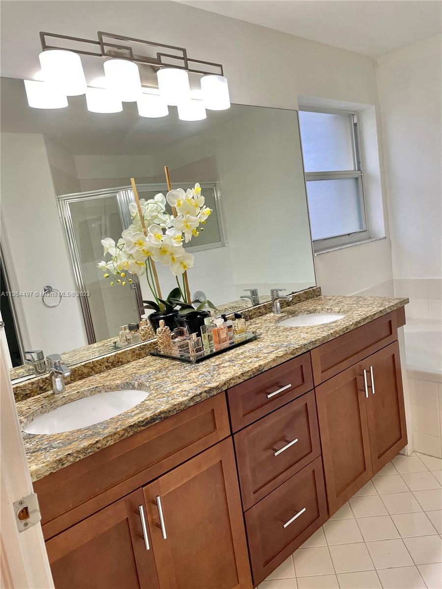 15542 Southwest 148th Terrace Miami, FL 33196 - Photo 29 of 38 a bathroom with a granite countertop sink and a mirror