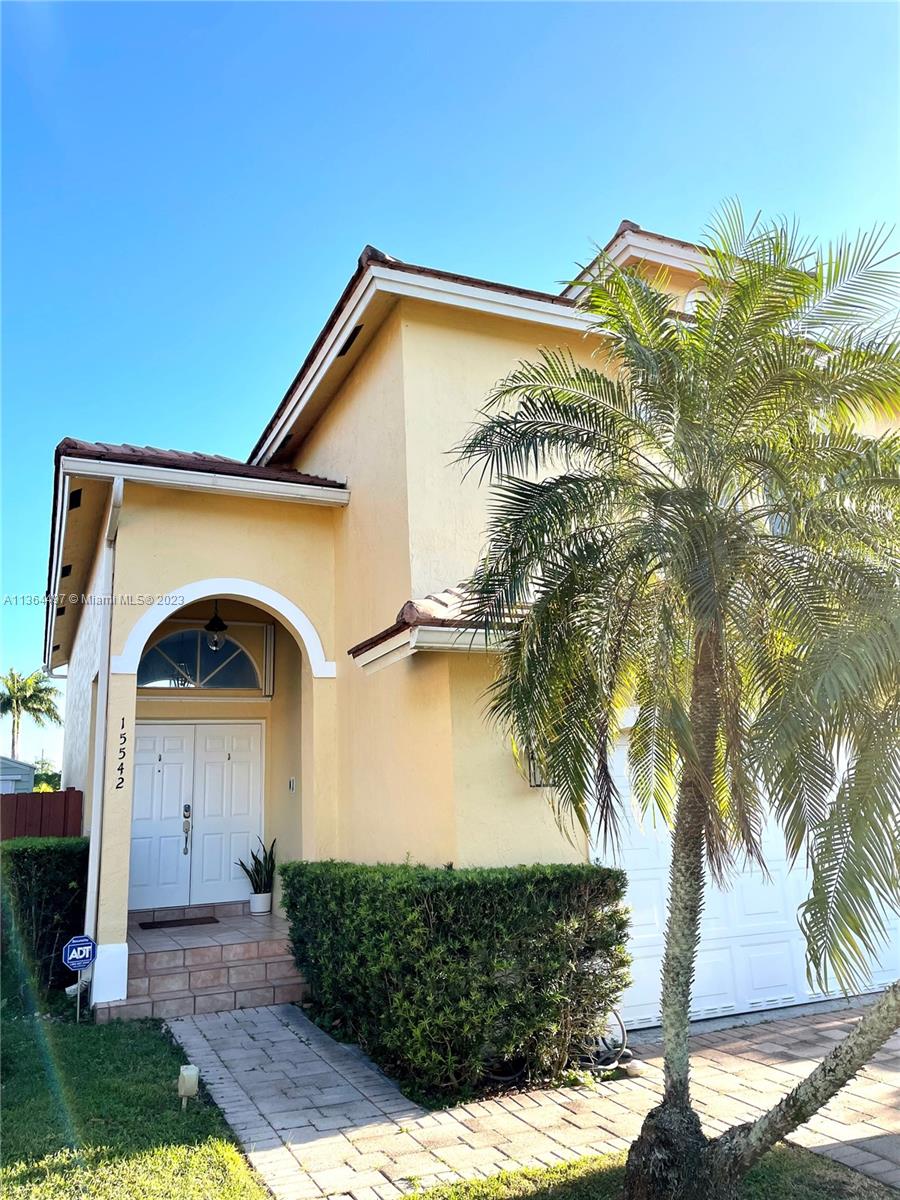 15542 Southwest 148th Terrace Miami, FL 33196 - Photo 3 of 38 a front view of a house with garden