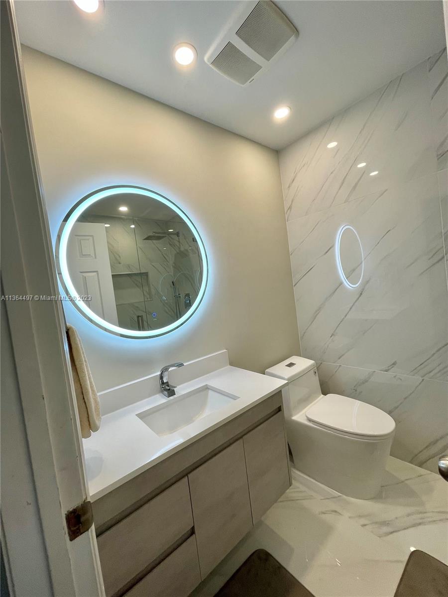 15542 Southwest 148th Terrace Miami, FL 33196 - Photo 33 of 38 a bathroom with a sink a toilet and a mirror