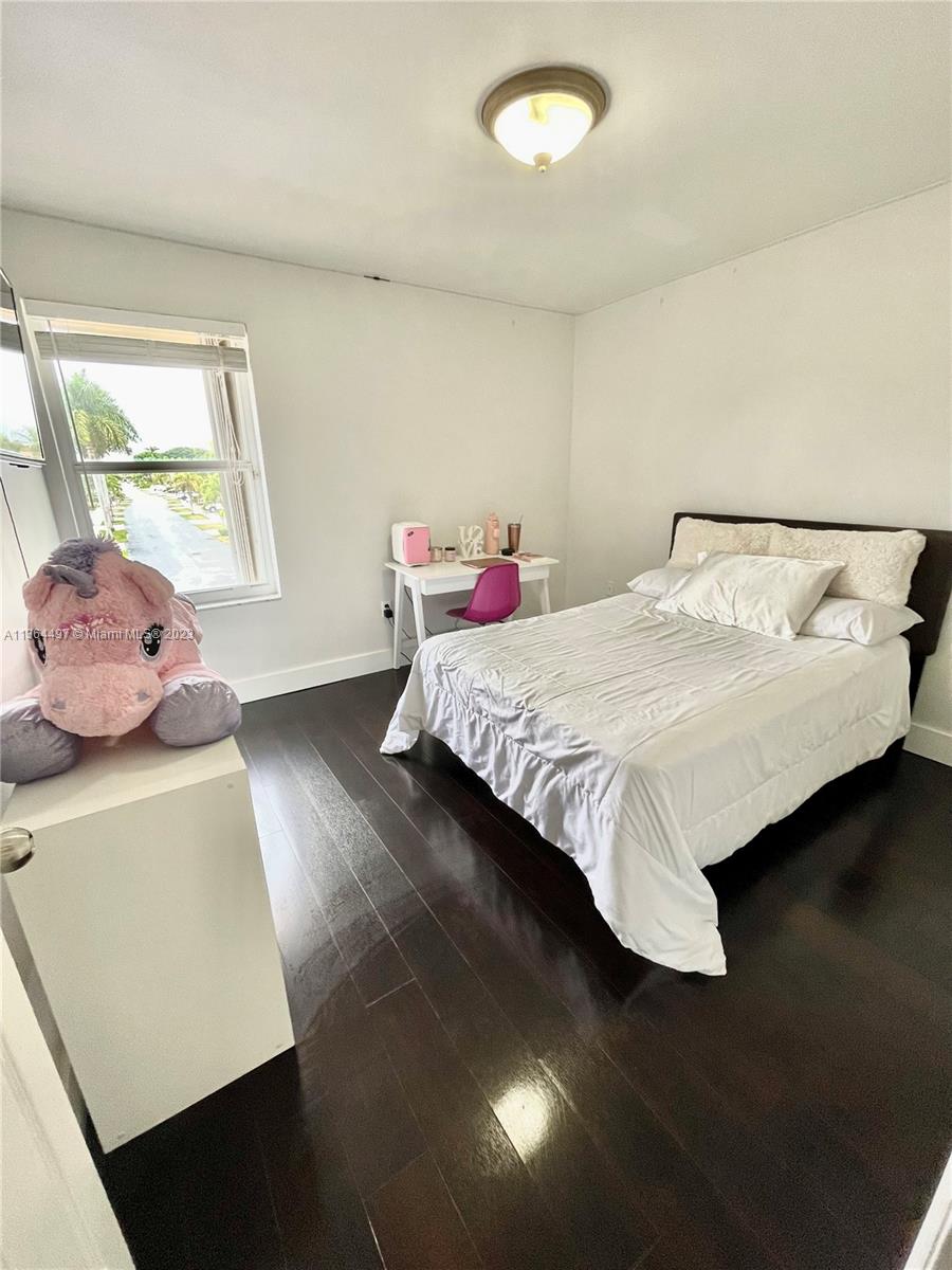 15542 Southwest 148th Terrace Miami, FL 33196 - Photo 34 of 38 a bedroom with a bed and window