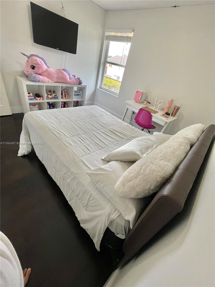 15542 Southwest 148th Terrace Miami, FL 33196 - Photo 35 of 38 a bedroom with a bed and window