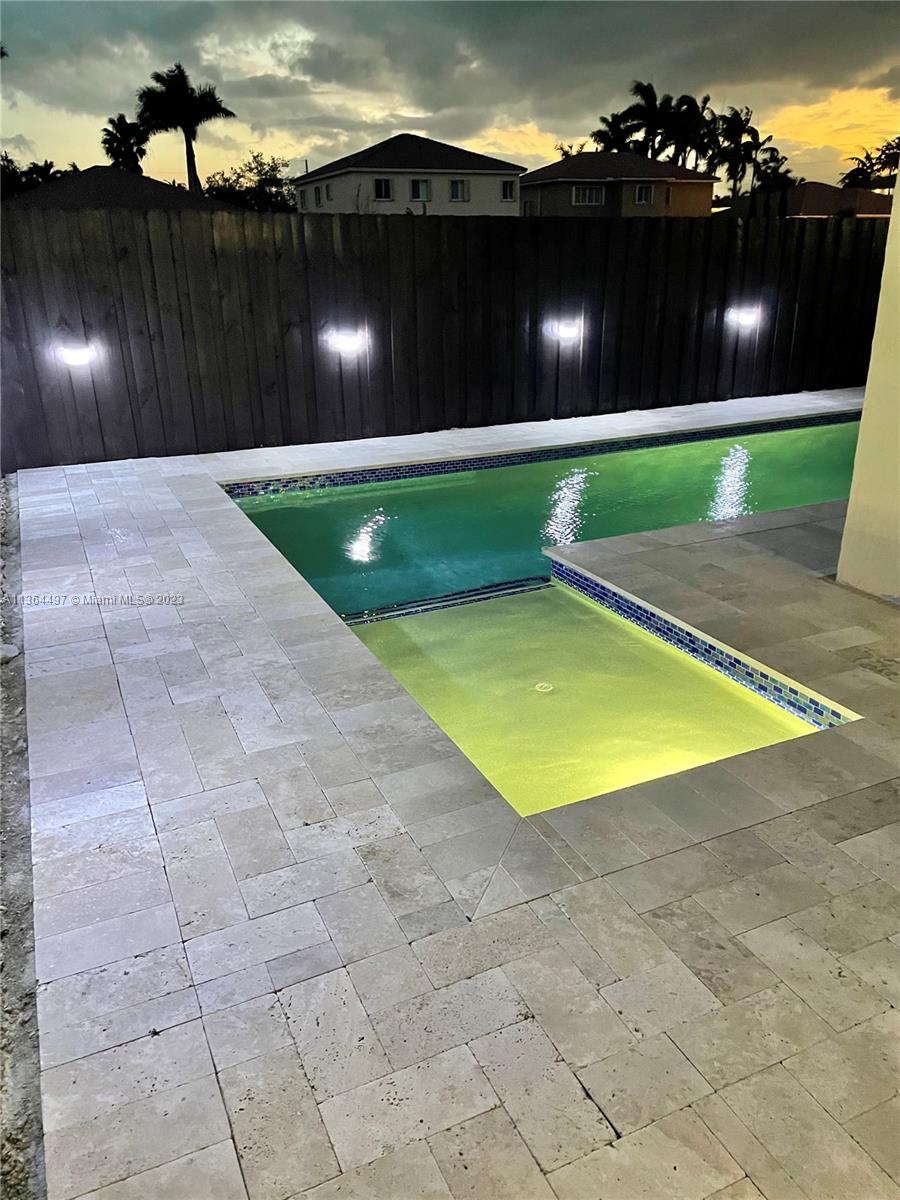 15542 Southwest 148th Terrace Miami, FL 33196 - Photo 7 of 38 a view of a swimming pool with an outdoor space and seating area