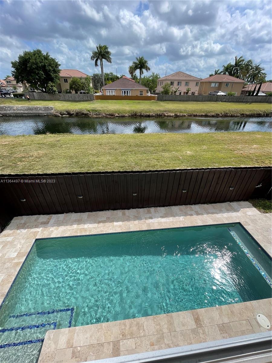 15542 Southwest 148th Terrace Miami, FL 33196 - Photo 8 of 38 a view of a swimming pool with a lake