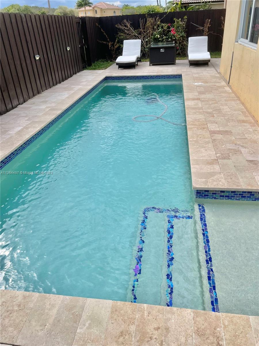 15542 Southwest 148th Terrace Miami, FL 33196 - Photo 9 of 38 swimming pool view with a garden