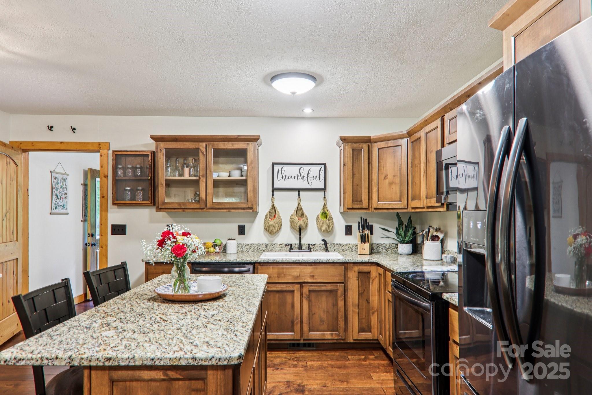 2171 Black Rock Road Cherokee, NC 28719 - Photo 11 of 36 a kitchen with granite countertop kitchen island stainless steel appliances a sink stove and refrigerator