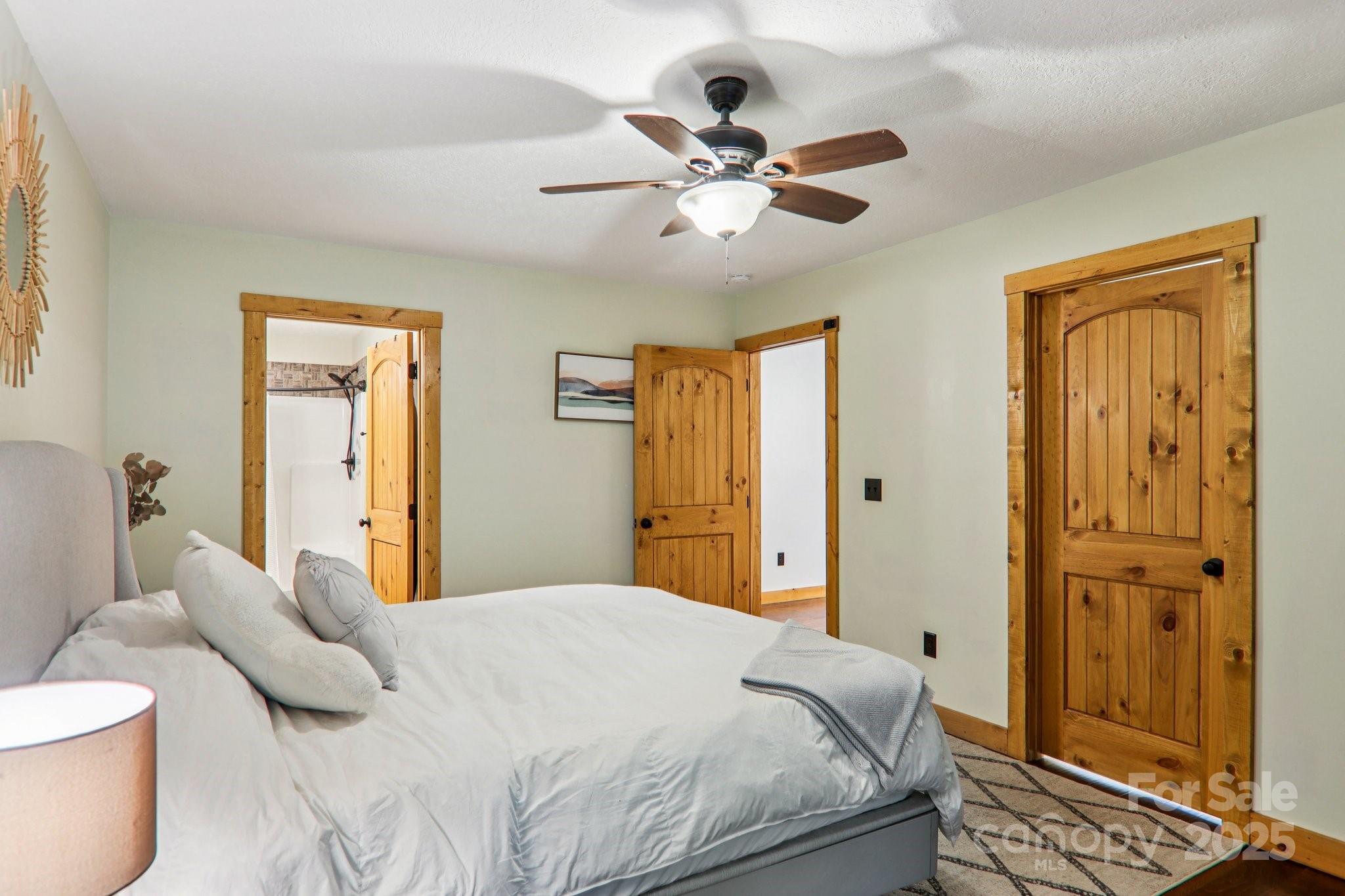 2171 Black Rock Road Cherokee, NC 28719 - Photo 15 of 36 a bedroom with a bed and a chandelier