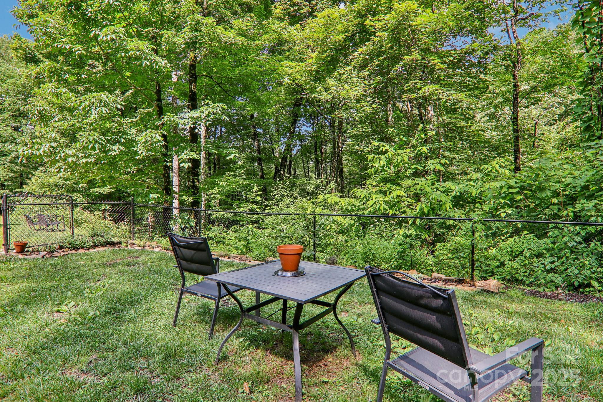 2171 Black Rock Road Cherokee, NC 28719 - Photo 35 of 36 a backyard of a house with table and chairs