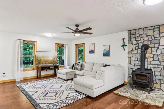 a living room with furniture a rug and a table
