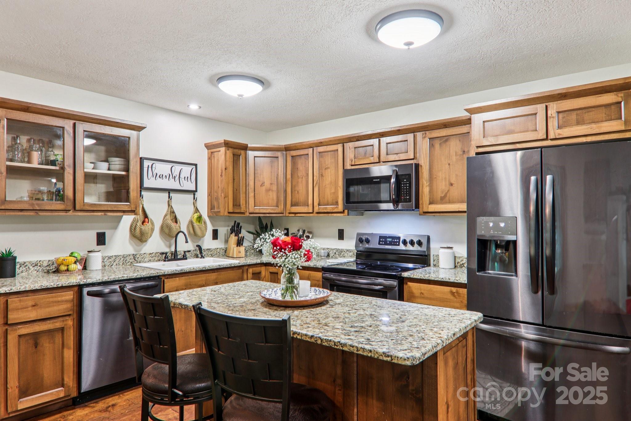 2171 Black Rock Road Cherokee, NC 28719 - Photo 10 of 36 a kitchen with stainless steel appliances granite countertop a sink refrigerator and microwave