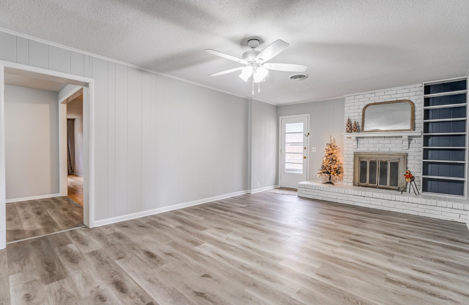 512 Fleda Road Memphis, TN 38120 - Photo 11 of 26 a view of an empty room with wooden floor and a window