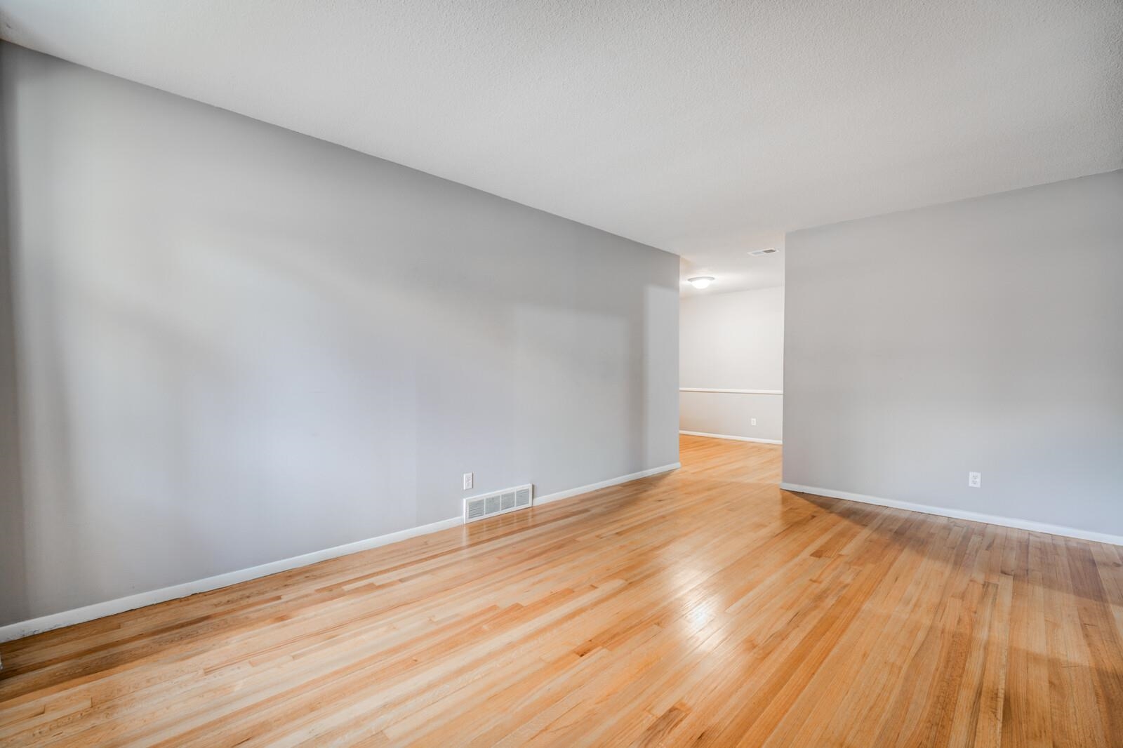512 Fleda Road Memphis, TN 38120 - Photo 4 of 26 a view of an empty room with wooden floor