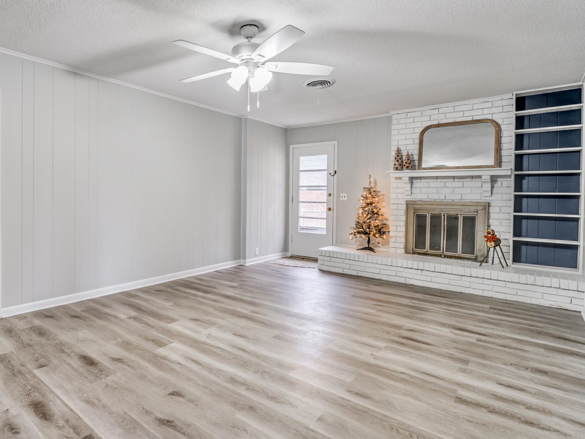 512 Fleda Road Memphis, TN 38120 - Photo 10 of 26 wooden floor fireplace and windows in an empty room