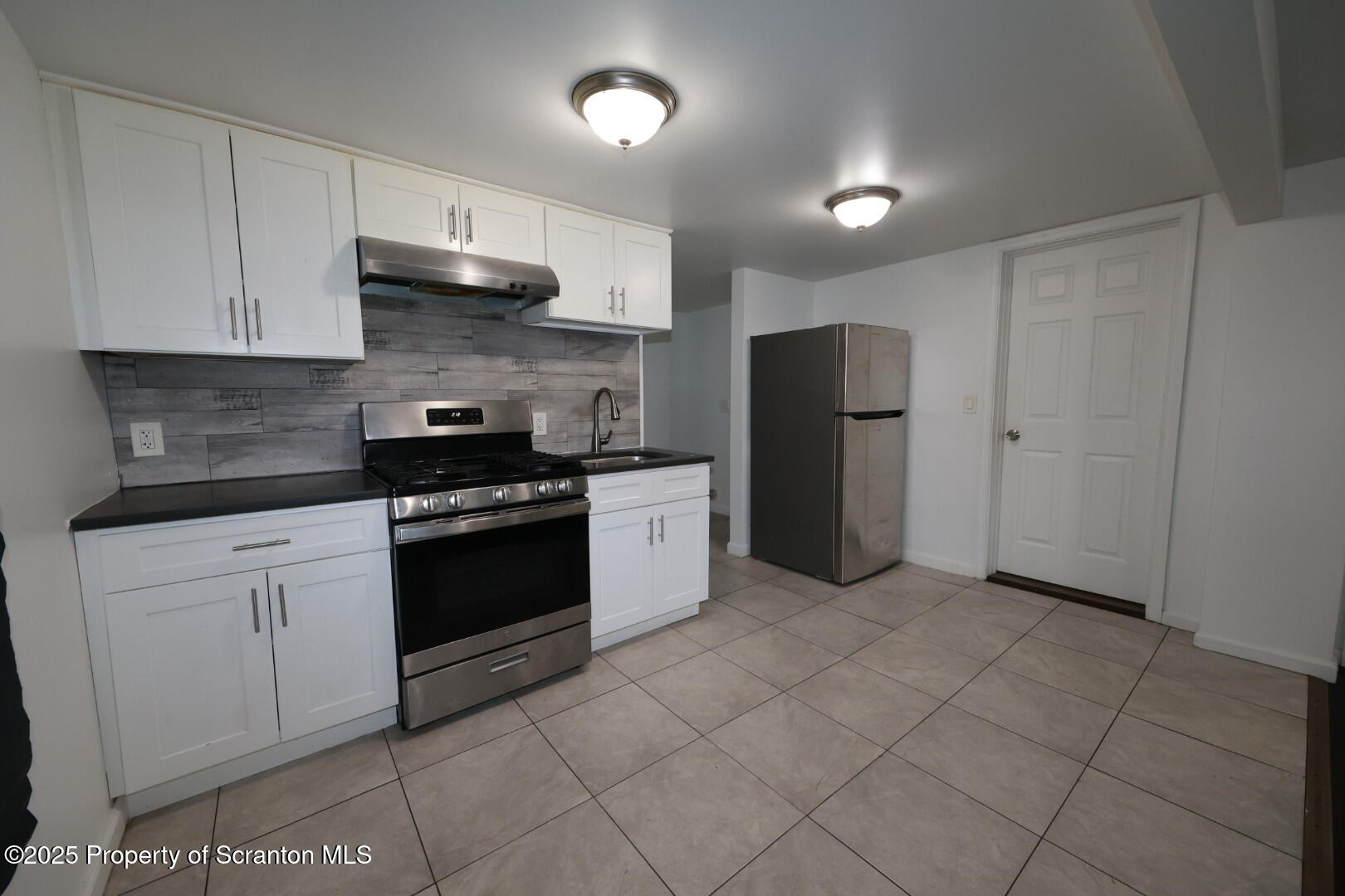 189 Nottingham Street, Unit 3 Plymouth, PA 18651 - Photo 4 of 14 a kitchen with stainless steel appliances granite countertop a refrigerator and a sink
