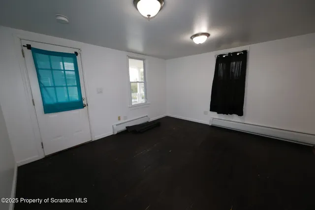 an empty room with wooden floor and closet