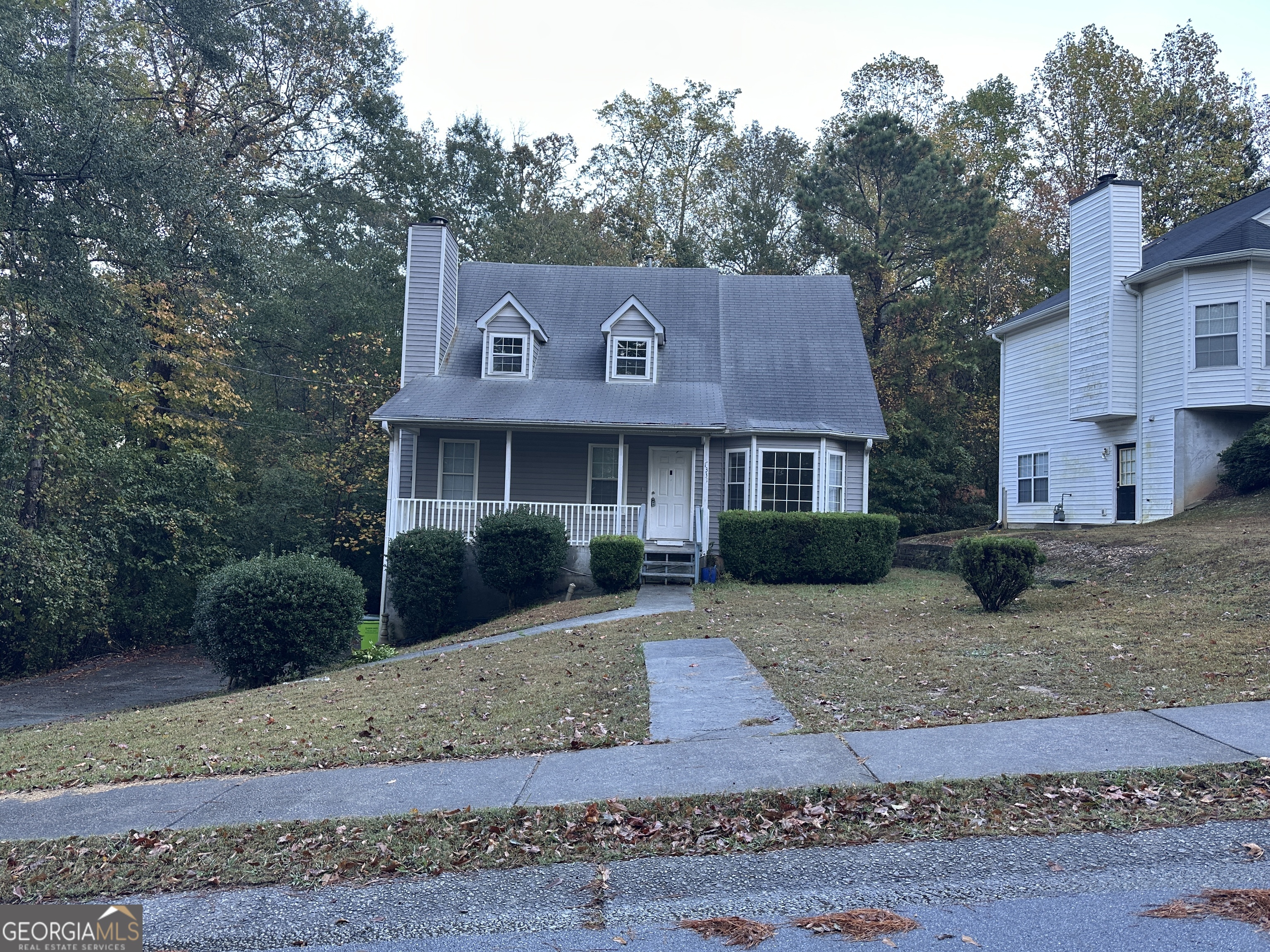 a front view of a house with a garden