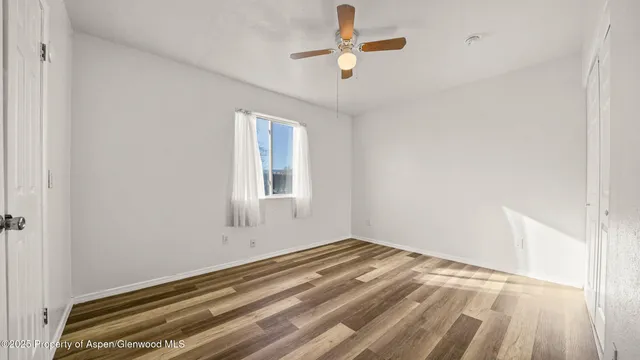 a view of a house with backyard and wooden fence
