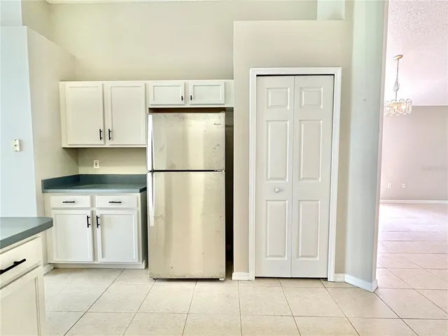 a kitchen with cabinets and refrigerator