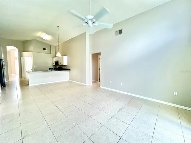 a view of a kitchen with a sink and a chandelier fan