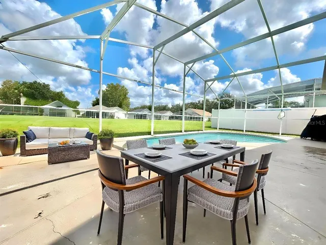 a view of a dinning table and chairs in the patio